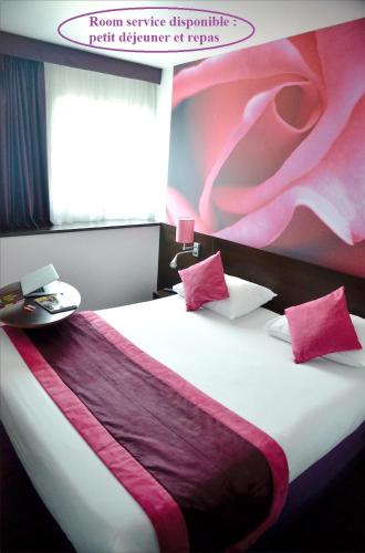 a bedroom with a bed with pink and purple sheets at ibis Styles Angers Centre Gare in Angers