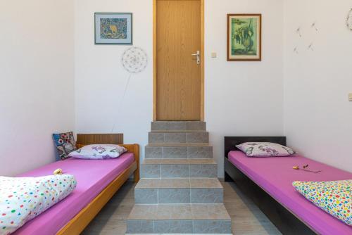 Postel nebo postele na pokoji v ubytování Apartments Biserka in Banjole