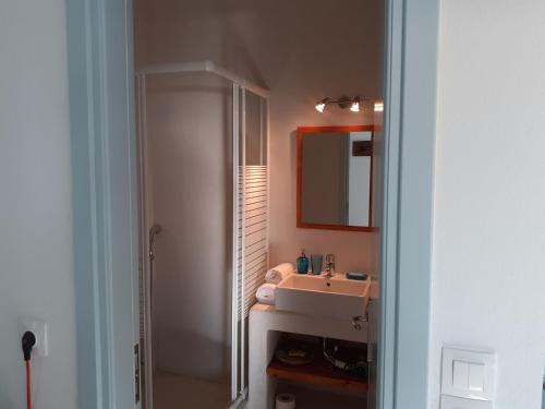 a bathroom with a sink and a mirror at Katoikia Spathi in Spathi 