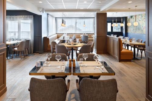 a dining room with wooden tables and chairs at Hôtel Marielle in Val Thorens