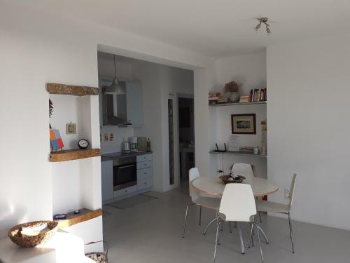 a kitchen and dining room with a table and chairs at Katoikia Spathi in Spathi 