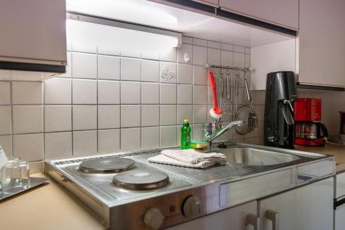 a kitchen counter with a sink and a stove at Haus Buchhammer in Fiss