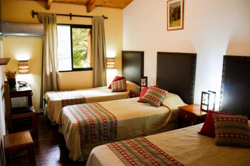 מיטה או מיטות בחדר ב-Hotel Tafí