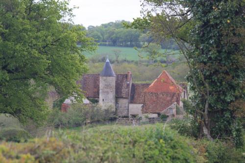 an old house in the middle of a field with trees at Chateau Mareuil in Brigueuil-le-Chantre