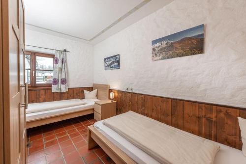 a bedroom with two beds and a window at Gästehaus Prugger by Schladmingurlaub in Ramsau am Dachstein