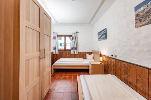 a small room with a bed and a window at Gästehaus Prugger by Schladmingurlaub in Ramsau am Dachstein