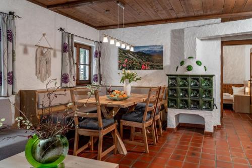 a dining room with a wooden table and chairs at Gästehaus Prugger by Schladmingurlaub in Ramsau am Dachstein