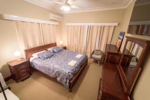 Bõucher Manor - Northam في نورثام: غرفة نوم مع سرير مع لحاف أزرق