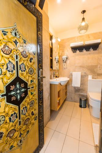 a bathroom with a door that has a cross on it at Riad Fes Nass Zmane in Fès