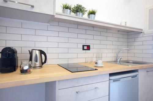 a kitchen with a sink and a counter top at Kouros Village in Antiparos Town