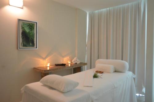 a room with two beds and a table with candles at Altos del Arapey All Inclusive, Golf & Spa in Termas del Arapey