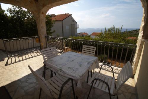 a patio with a table and chairs on a balcony at Murter Inn in Murter