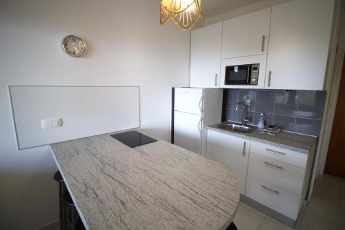 a kitchen with a table and a counter top at Murter Inn in Murter