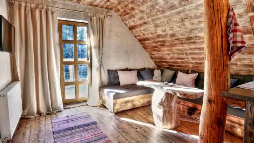 a living room with a couch and a window at Chata Baba Yaga in Ždiar