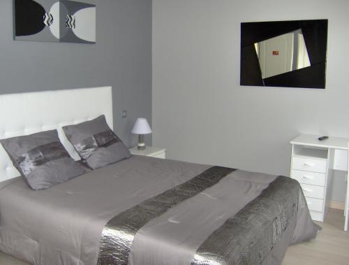 um quarto com uma cama grande e um espelho em Chambres d'hôtes Les Lavandes Rocamadour em Rocamadour