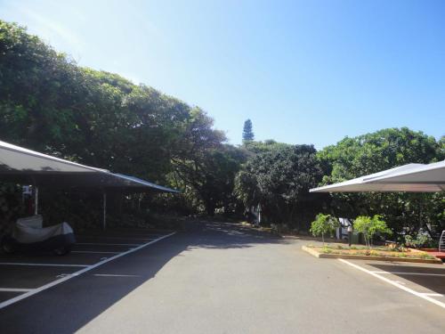 a parking lot with trees on the side of a road at Chakas Cove in Ballito