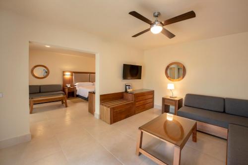 a living room with a couch and a bed at Occidental Punta Cana - All Inclusive in Punta Cana