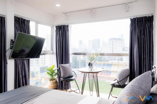 a bedroom with a bed and a large window at Libré Homestay in Hanoi