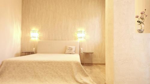 a bedroom with a bed with two lights on it at Sea Garden Apartment in Varna City