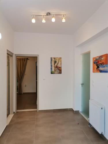an empty room with white walls and tile floors at Chez Kiki et Ioannis in Naxos Chora
