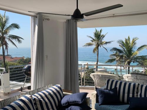 a living room with a view of the ocean at Chakas Cove in Ballito
