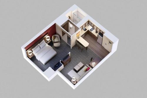aometric view of a room with a bed and a desk at Staybridge Suites Charlottesville Airport by IHG in Charlottesville