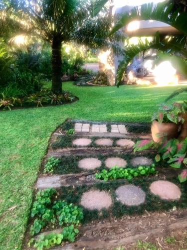 a path in a yard with green plants at Jock of the Bushveld in Barberton