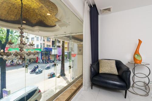 a chair in a window with a view of a street at Lam Kinh Hotel in Ho Chi Minh City