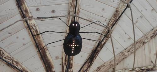 a black spider hanging from the ceiling of a building at Chata Baba Yaga in Ždiar