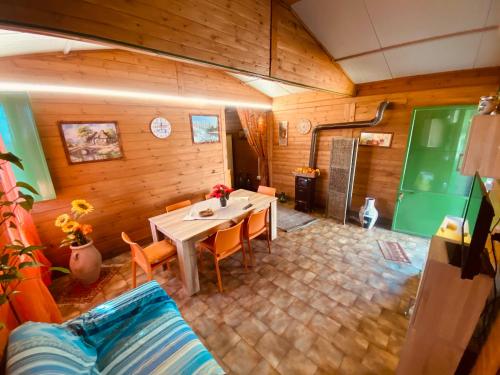 a living room with a table and chairs and a couch at CHALET IL GELSOMINO DELL'ETNA in Giarre