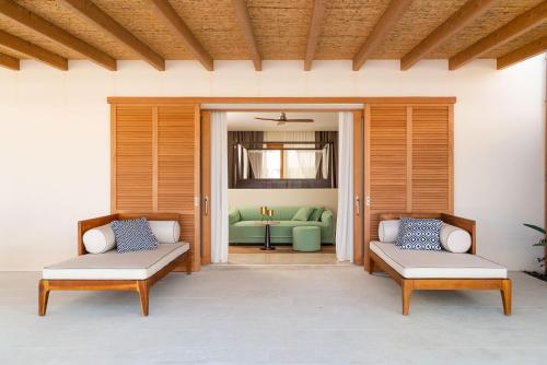 a patio with two chairs and a couch in the background at Il San Corrado di Noto in Noto