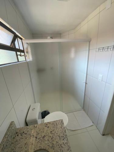 a bathroom with a toilet and a shower at Pousada El Shaddai in Foz do Iguaçu