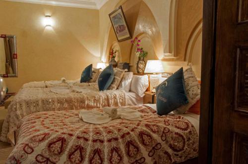 a hotel room with two beds in a room at Riad Merzouga in Marrakech