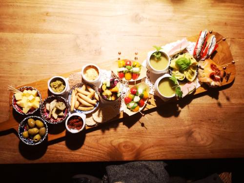 a table with a variety of appetizers and dishes of food at Casa Leone near Bruges with jacuzzi & parking in Ruddervoorde