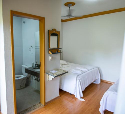 Кровать или кровати в номере Pousada Chafariz das 4 Estações