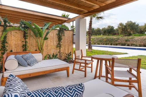 a patio with a couch and a table and chairs at Il San Corrado di Noto in Noto