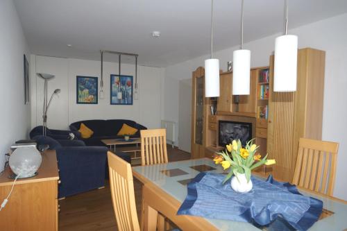 a kitchen and living room with a table and a couch at Ferienwohnungen an der Therme in Bad Rodach