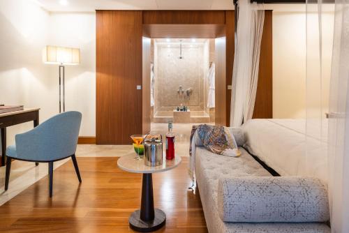 a living room with a couch and a bed and a table at Il San Corrado di Noto in Noto