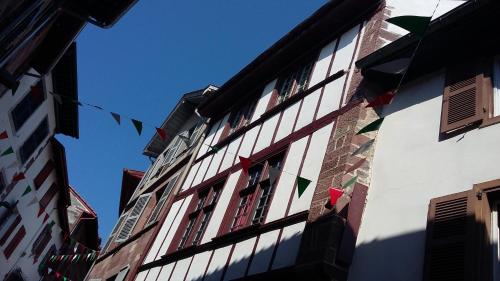 a building that has a bunch of windows on it at Gîte ULTREIA Vertes Montagnes in Saint-Jean-Pied-de-Port