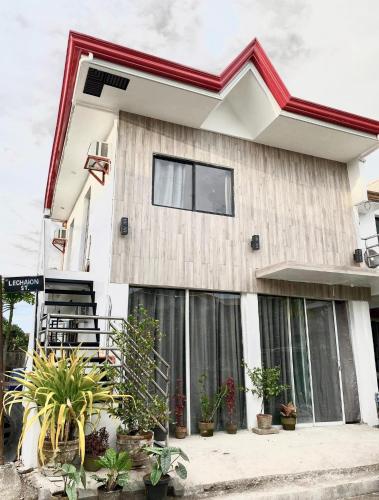 a house with plants in front of it at Best studio flat w/ NETFLIX near airport and beach! in Mactan