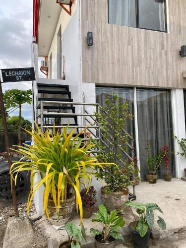 a porch of a building with plants and a chair at Best studio flat w/ NETFLIX near airport and beach! in Mactan
