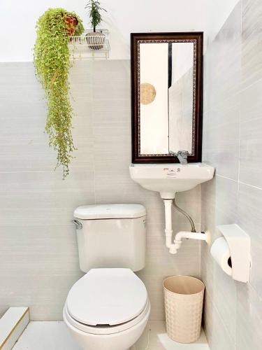 a bathroom with a toilet and a sink at Best studio flat w/ NETFLIX near airport and beach! in Mactan