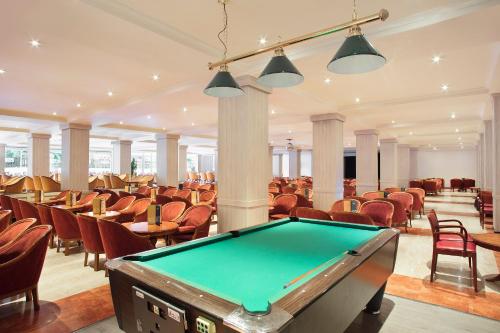 a pool table in a room with chairs at Sol Pelicanos Ocas in Benidorm