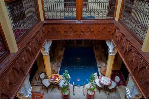 an overhead view of a swimming pool in a building at Riad Merzouga in Marrakech