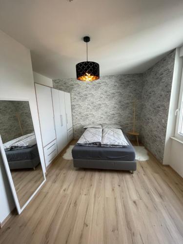 a bedroom with two beds and a chandelier at Joanna Apartment - MA Rheinau in Mannheim