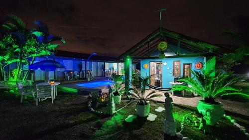 a house with green lights in the yard at Pousada da Praia in Itaipuaçu