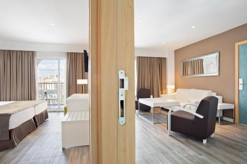 貝尼多姆的住宿－索爾佩里卡諾奧卡斯酒店，酒店客房配有一张床铺和一张桌子。