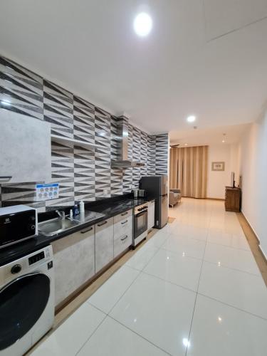 a large kitchen with a sink and a dishwasher at Royale Suites by Arc Royal Luxury Apts in Anse Royale