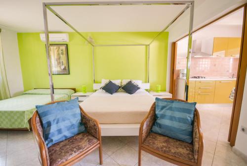 a bedroom with two beds and two chairs at Haus Roko in Rovinj