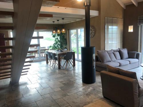 a living room with a couch and a table at Le champ Madame in Stavelot